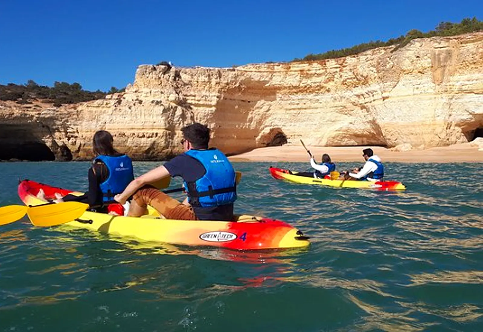 Kayaks travelling below the Algarve cliffs