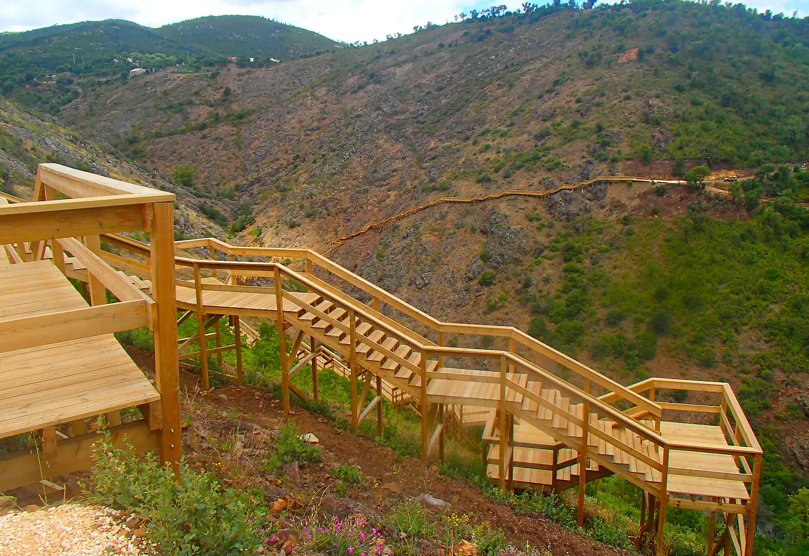 Wooden Passadiços do Demo walkway in the Monchique landscape