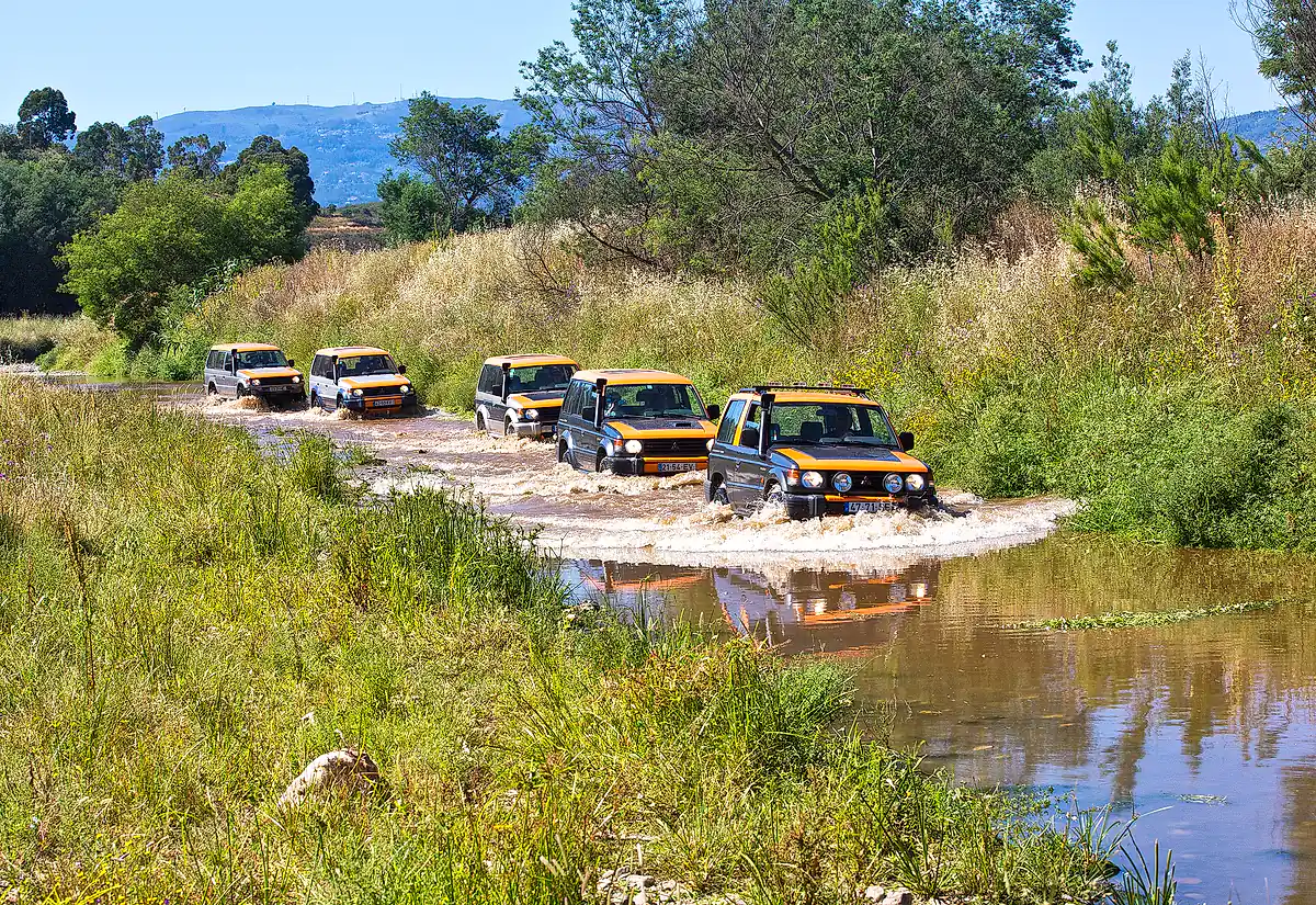 Jeep convoy crossing water beside the River Arade